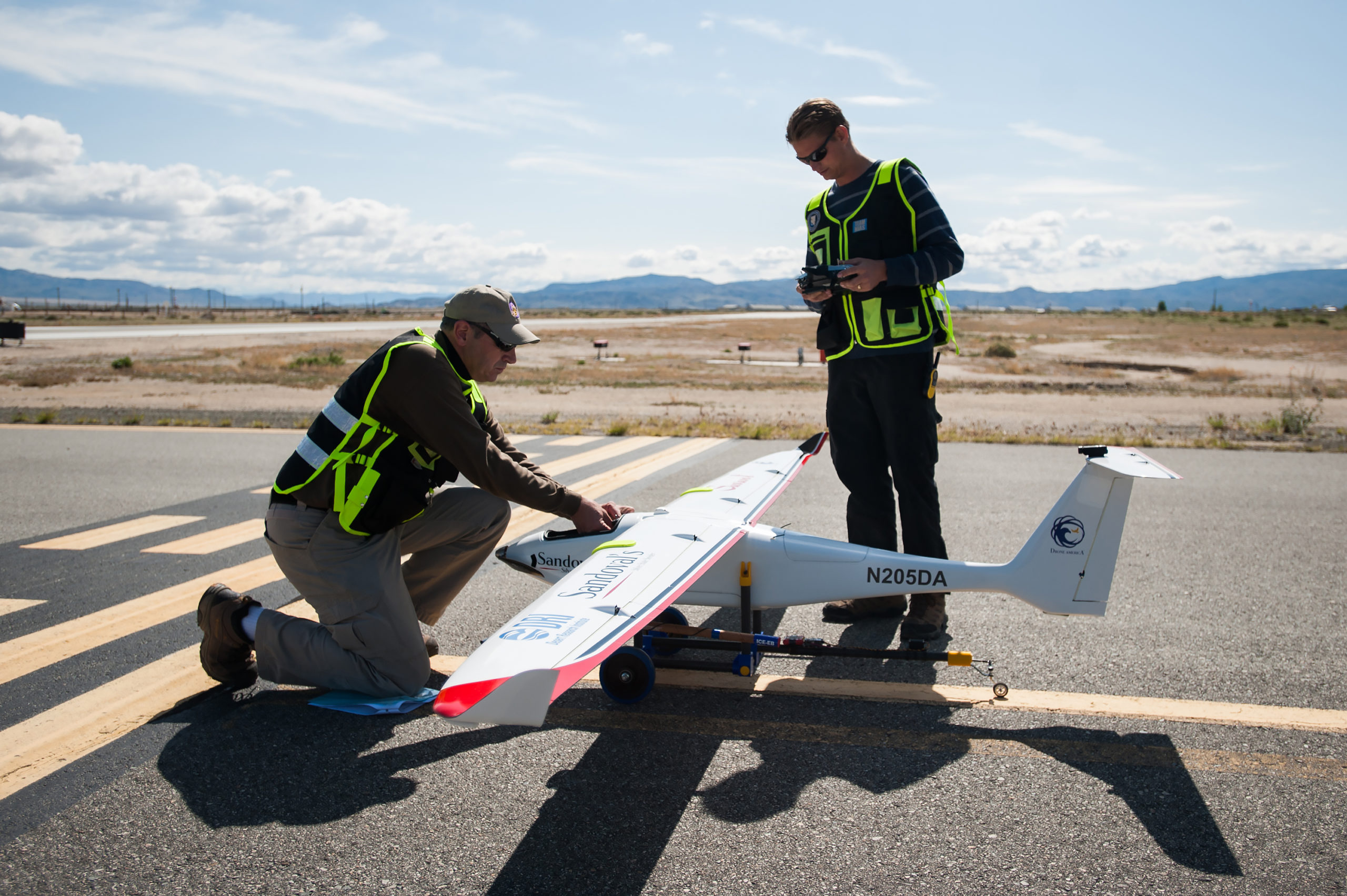 (From Left) Drone America's Todd Richman, pilot, and Kyle Pruett, engineer and pilot, prepare to test fly the Savant sUAS with cloud seeding flares at the Hawthorne Industrial Airport in Hawthorne, Nev. on Friday, April 29, 2016. The Savant flew to 400 feet and was successful in igniting two silver-iodide cloud seeding flares. Photo by Kevin Clifford/Drone America