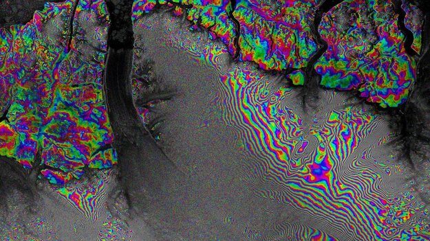Radar interferometry is powerful to demonstrate subsidence or land surface shifts. The image at hand show the Petermann Glacier within a time frame of 24 days. The rainbow coloured areas entail zones of subsidence or risings. One colour phase (e.g. from red to red) refers to the absolute number of surface difference and is half of the wave length. Source: ESA