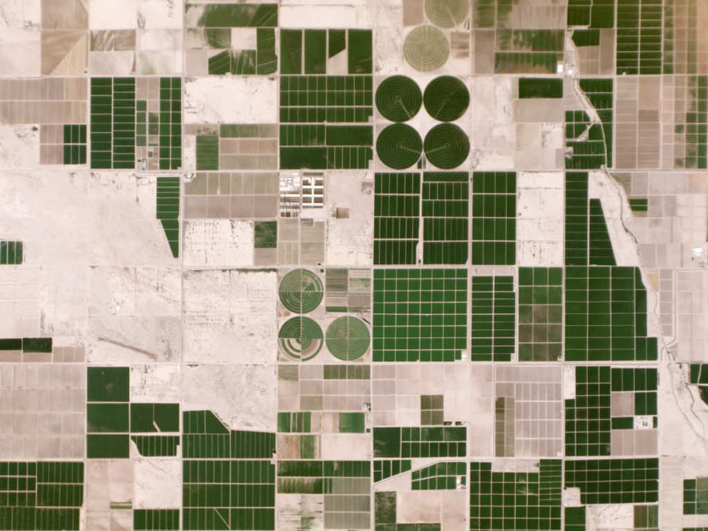 Irrigated Fields, Arizona, USA. August 16, 2014. Dark green fields stand out against the pale desert floor in Pinal County, Arizona. The region’s farms rely on irrigation, since they receive less than 10 inches of rain a year. Irrigation water comes from two main sources: the Colorado River and aquifers. Source: Wired 
