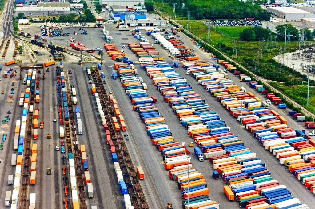 Colorful view of intermodal yard showing trains and shipping containers